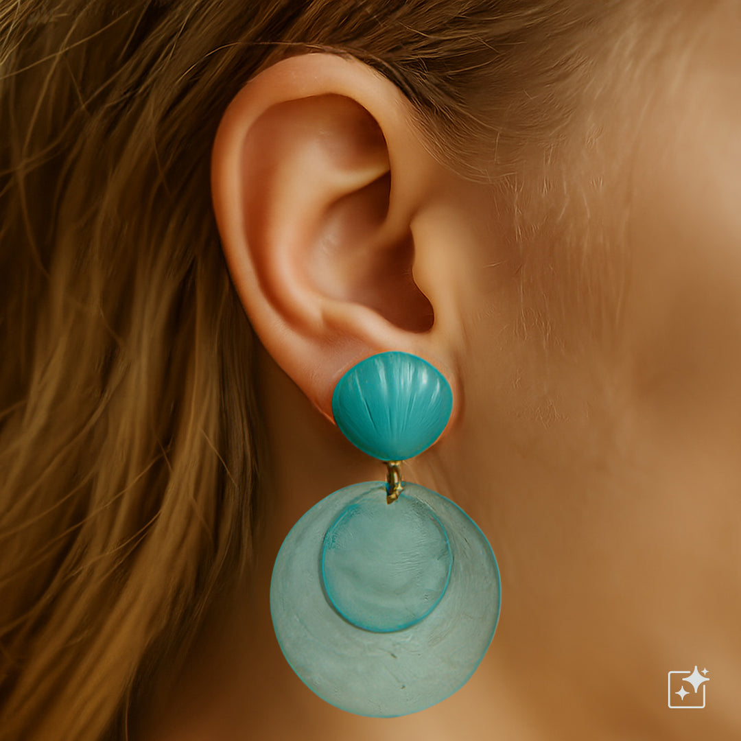 Hängande hockeyörhängen med snäckskal