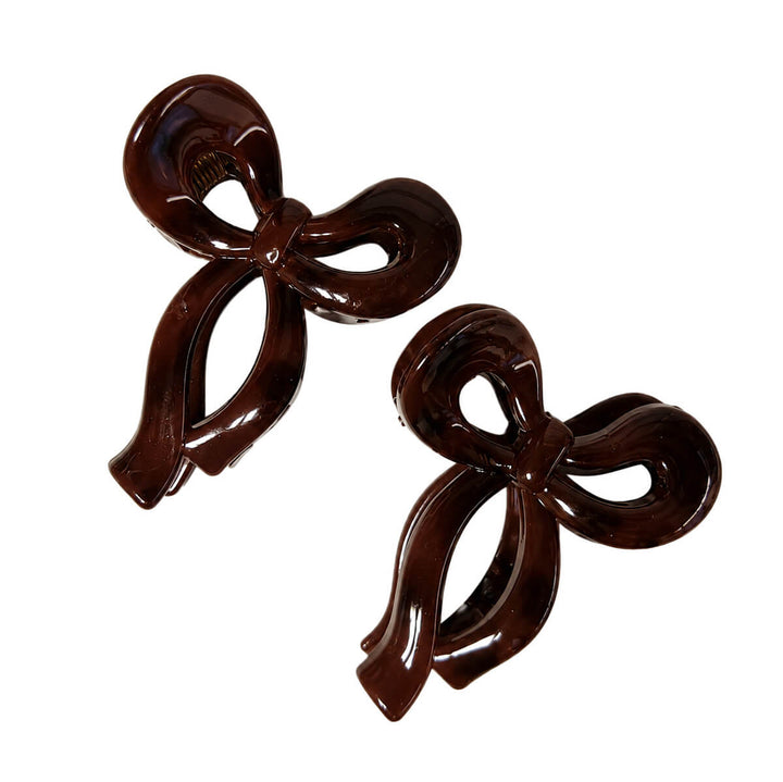 Small plastic bow-tie and shark-tooth hair clips, set of 2
